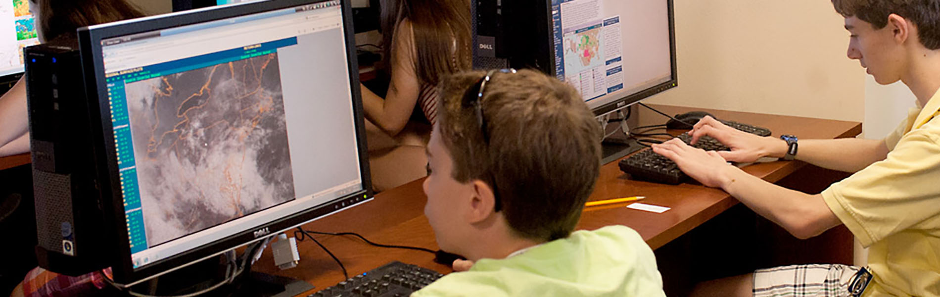 students at computers during weather camp