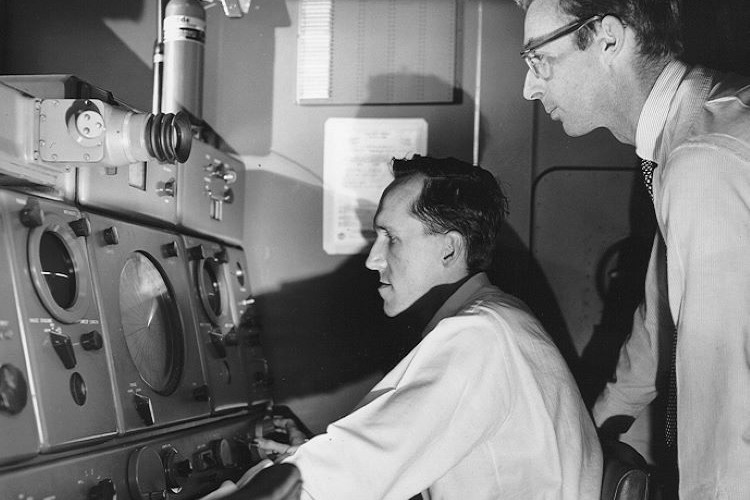 Charles Hosler and another gentleman looking at radar.