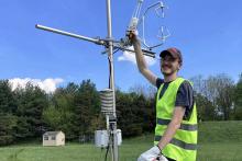 Nicholas Prince readies an eddy covariance flux tower for data collection in Baltimore.