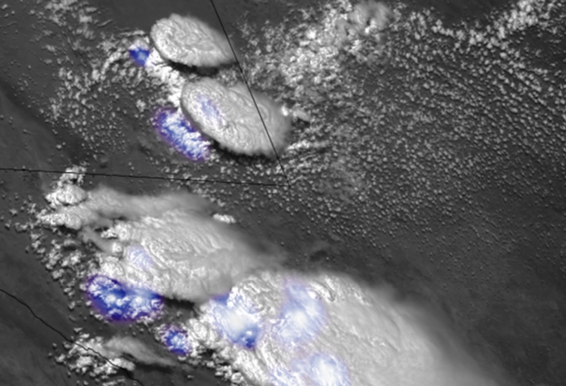 Convection initiation over the Central United States as viewed from the GOES-17 satellite. Clouds at various stages of development are seen in white , with lightning indicated by the blue shading. The prediction challenge is to determine which clouds will develop into thunderstorms in the next hour, researchers said.